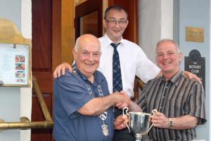 Picture shows Thornhill and District Rotary Club President Derek Clark presenting Gordon with his trophy. Looking on is event sponsor Robert Mitchell.