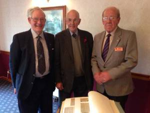 Ian Johnston shows the Scrapbook to other long-standing members.