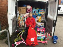 Rotarian Linda with a full van of donated toys delivered to Refuge HQ