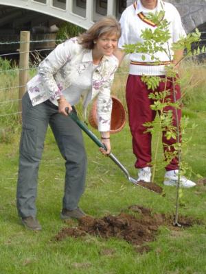 Susan Burgess planting the first tree