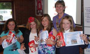 Members of the Diva Dolphins receive their prizes, certificates and our thanks for swimming.