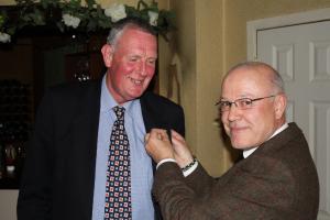 President Trevor Baxter welcomes new Rotarian Alan Nisbet into the club