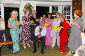 Incoming President Barry Seymour is serenaded by WRINGS ladies