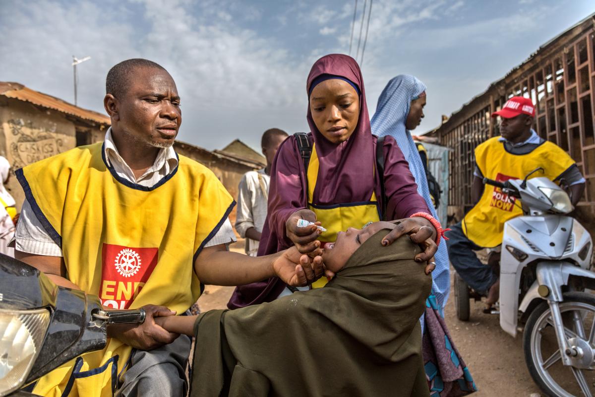 Administering polio drops to a child in Nigeria.  Image Rotary International