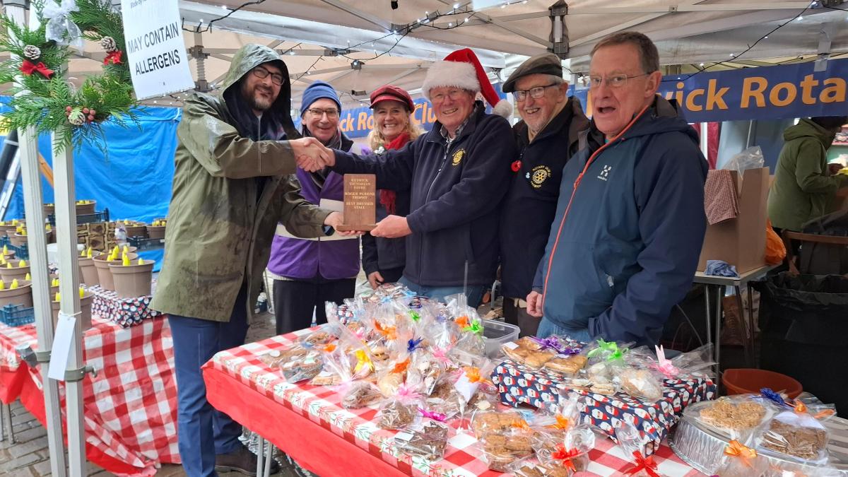 Local MP Marcus Campbell Savours presenting 'Best Stall' award to Keswick Rotary