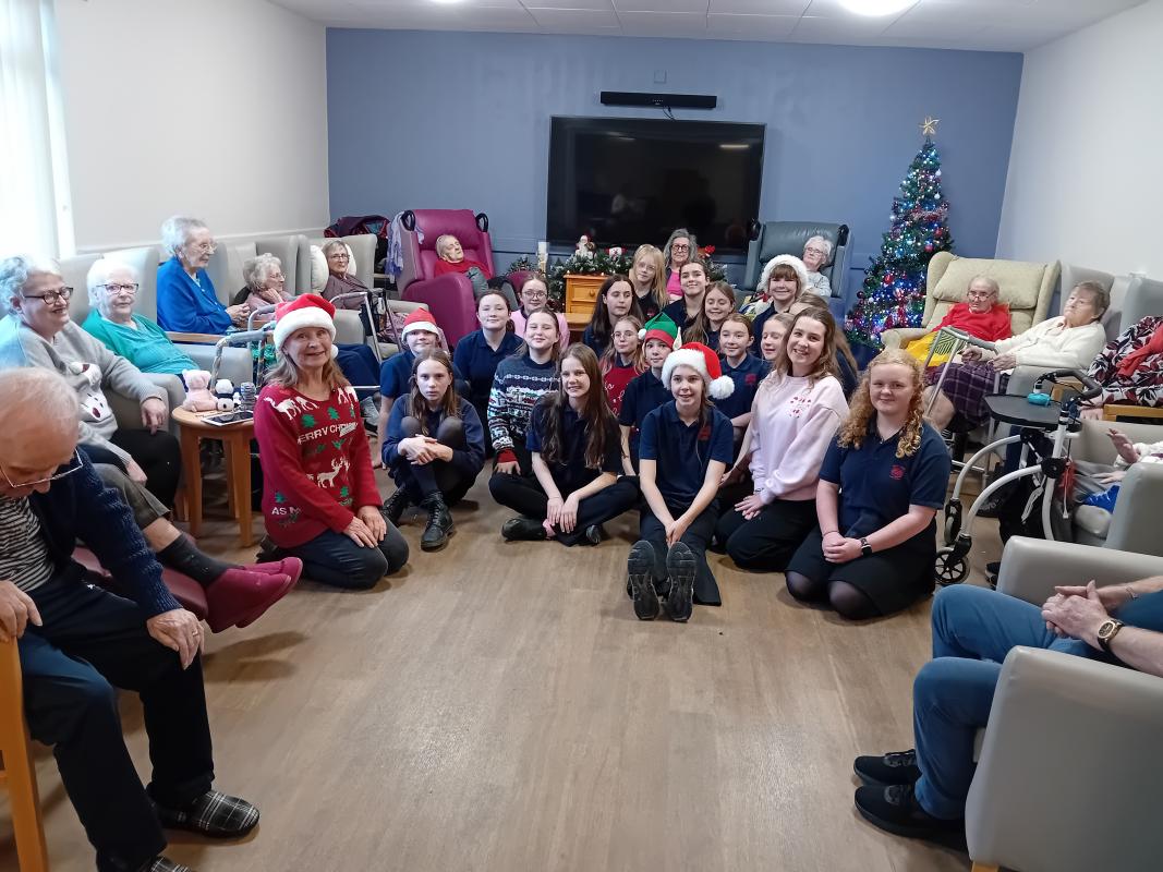 Ysgol Gyfun Aberaeron choir singing at Min y Mor Residential Home with Rotary in Cardigan Bay 