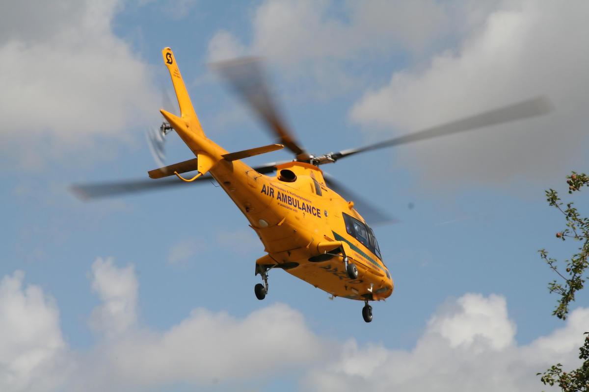 An air ambulance seen from below.