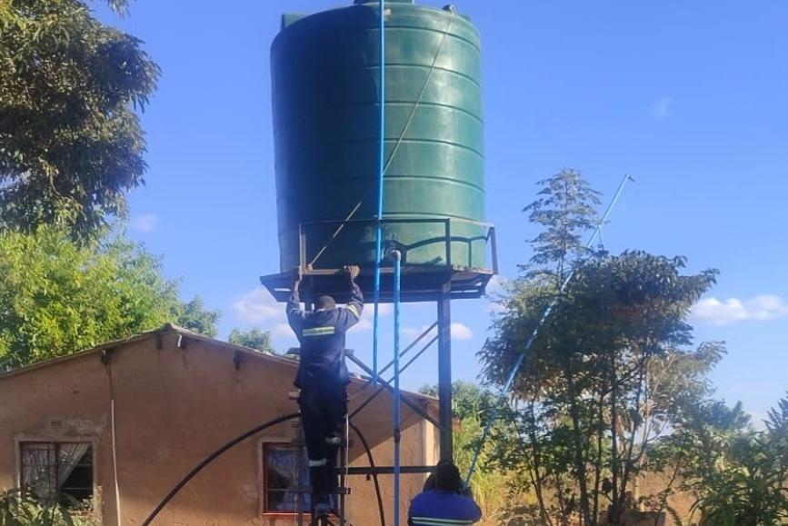The huge water tank being installed near the well to make the water project work.