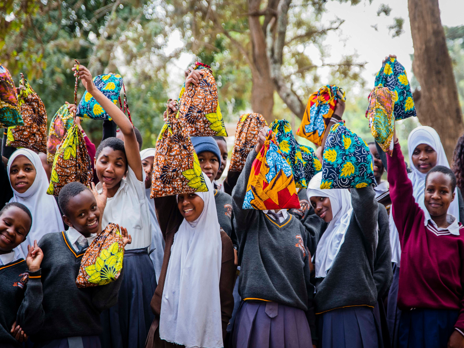 Photograph supplied by Tanzanian aid worker Alice Kostrzewa, shows a group of schoolchildren in Arusha, the United Republic of Tanzania, proudy displaying their personal hygiene kits, locally made from templates provided by Yorkits. 