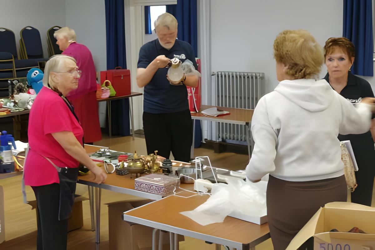 People getting ready for a jumble sale.