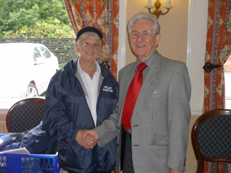 Gareth presenting his cheque to Sandra Edwards