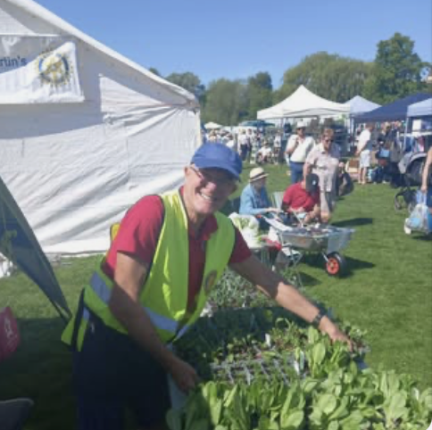 Rotarians busy tending fresh herbs for sale on the meadows