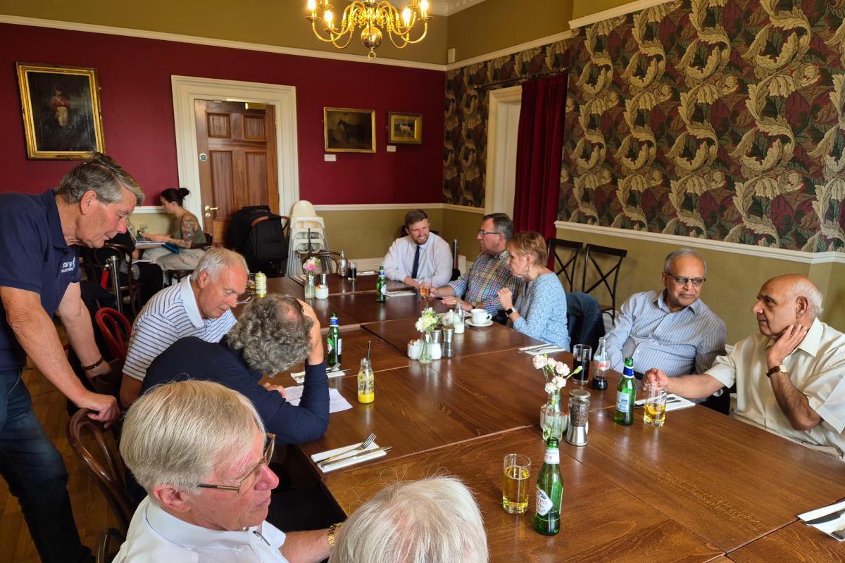 People around a long rectangular table.