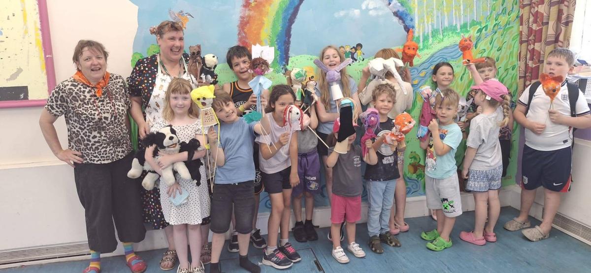 Children from Mile Cross proudly showing the puppets they made in the morning ! 