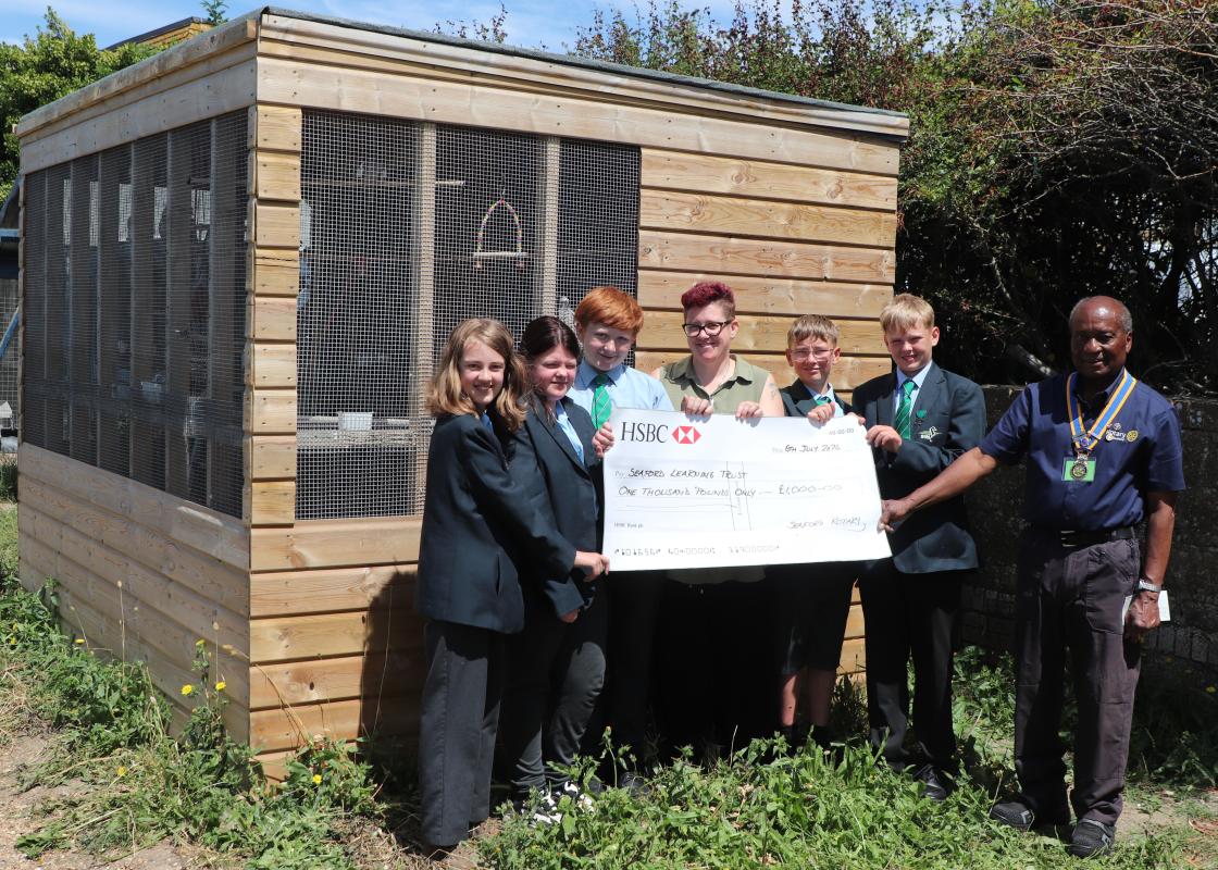 President Collins Griffith presenting the grant to SHS teacher Carly Perou supported by pupils Mollie, Mia, John, Jake and Josh