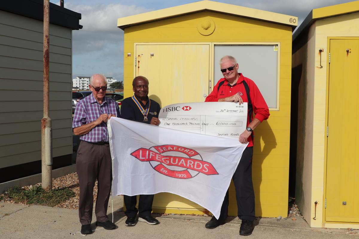 President Collins Griffith supported by Frank Thompson presenting Peter Gwilliam, Chairman, Seaford Lifeguards with the grant cheque outside Beach Hut 60