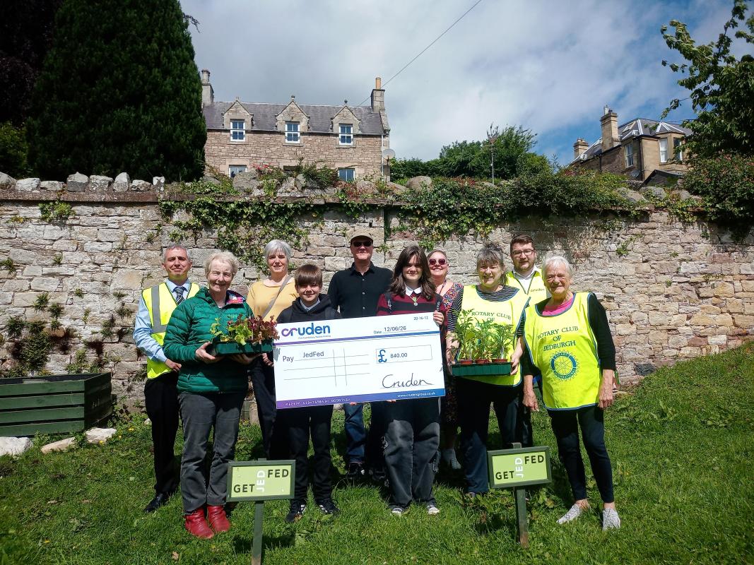 Cruden Homes hand over a cheque for creating a community garden