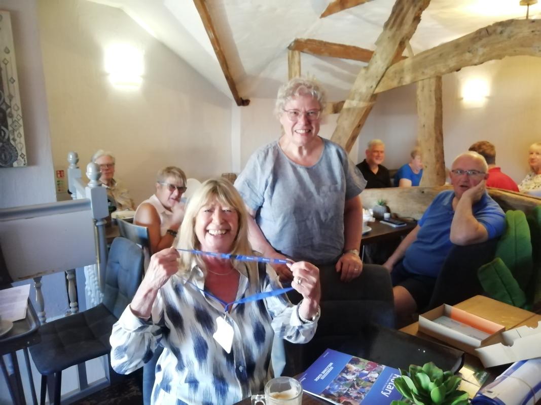 President Andrea (standing) and new member Beverley Bell