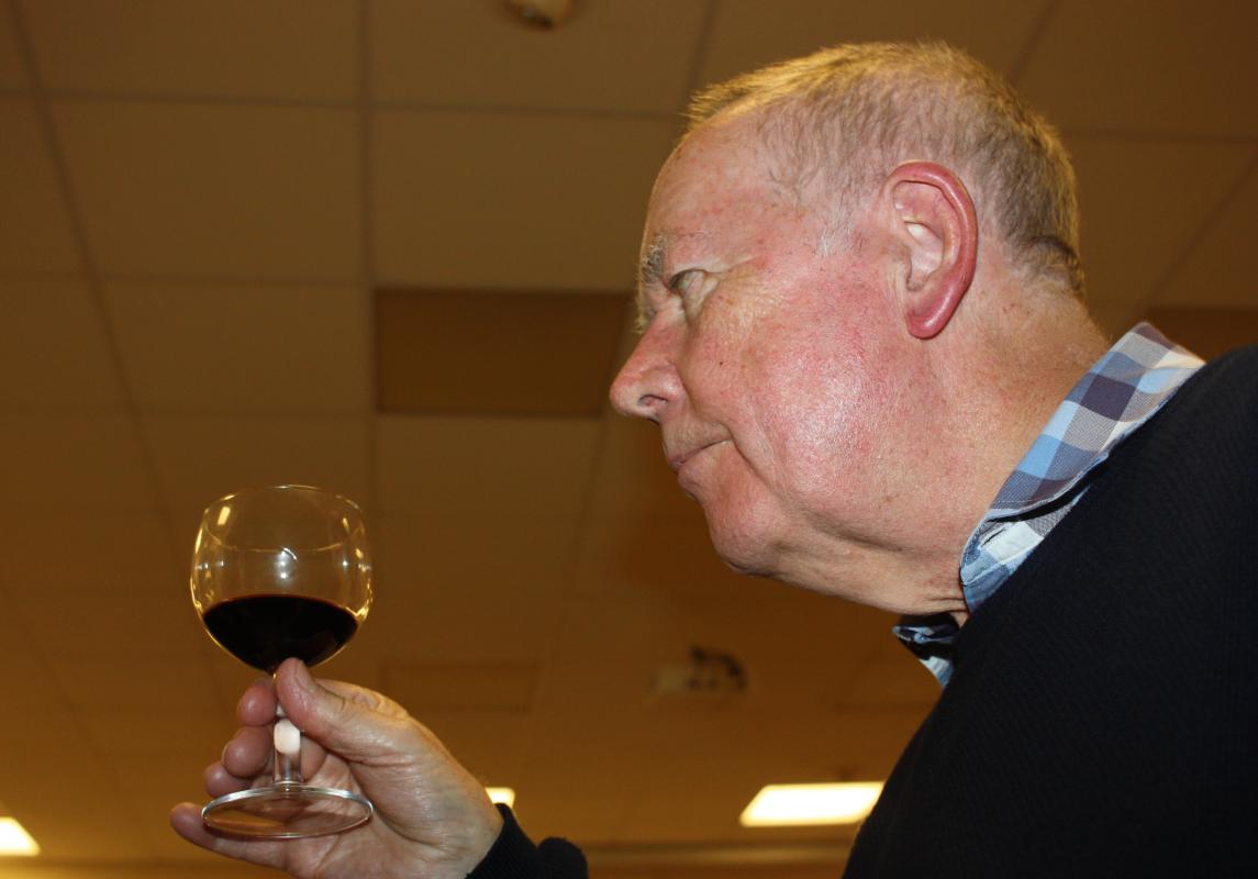 John in deep in wine-tasting concentration