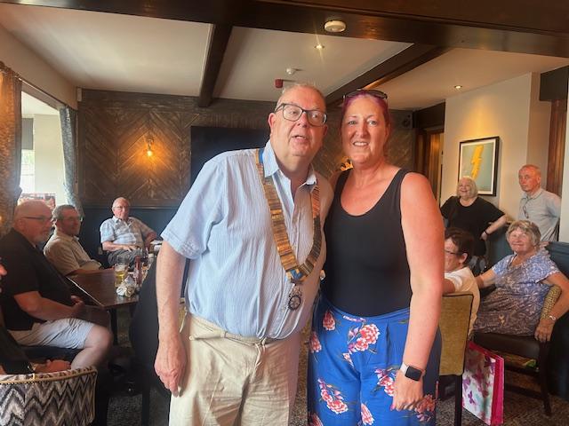 Amanda hands the chain of office to Peter.