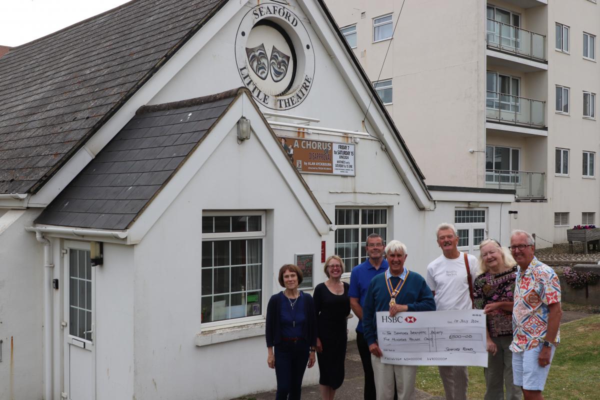 President Clive Livingstone presenting the donation to members of The Seaford Dramatic Society in front of Seaford Little Theatre. 