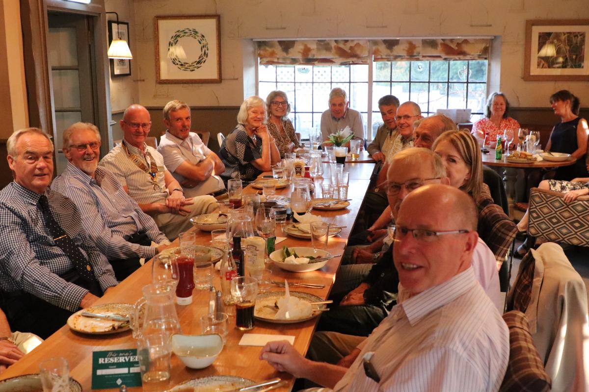 The crowed room with members recovering after the meal