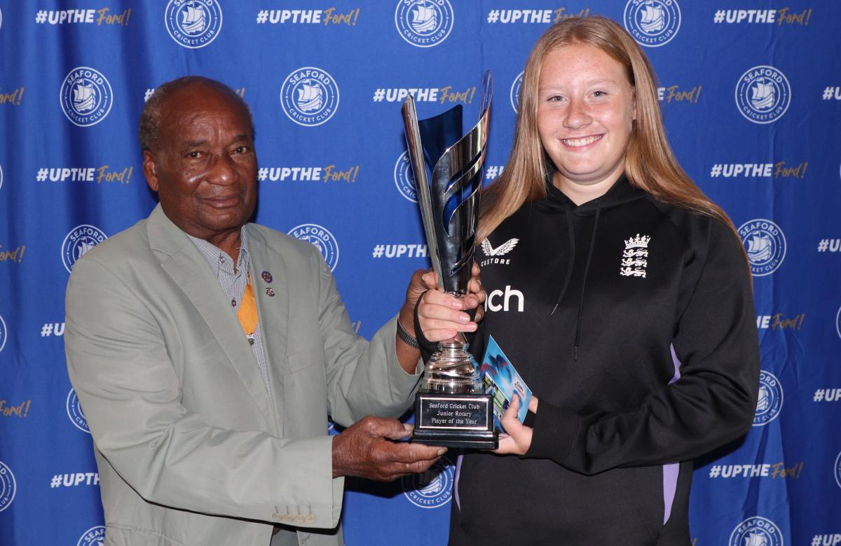 Vice President Collins Griffith presenting the Junior Rotary Player of the Year trophy to Sophia Peachey