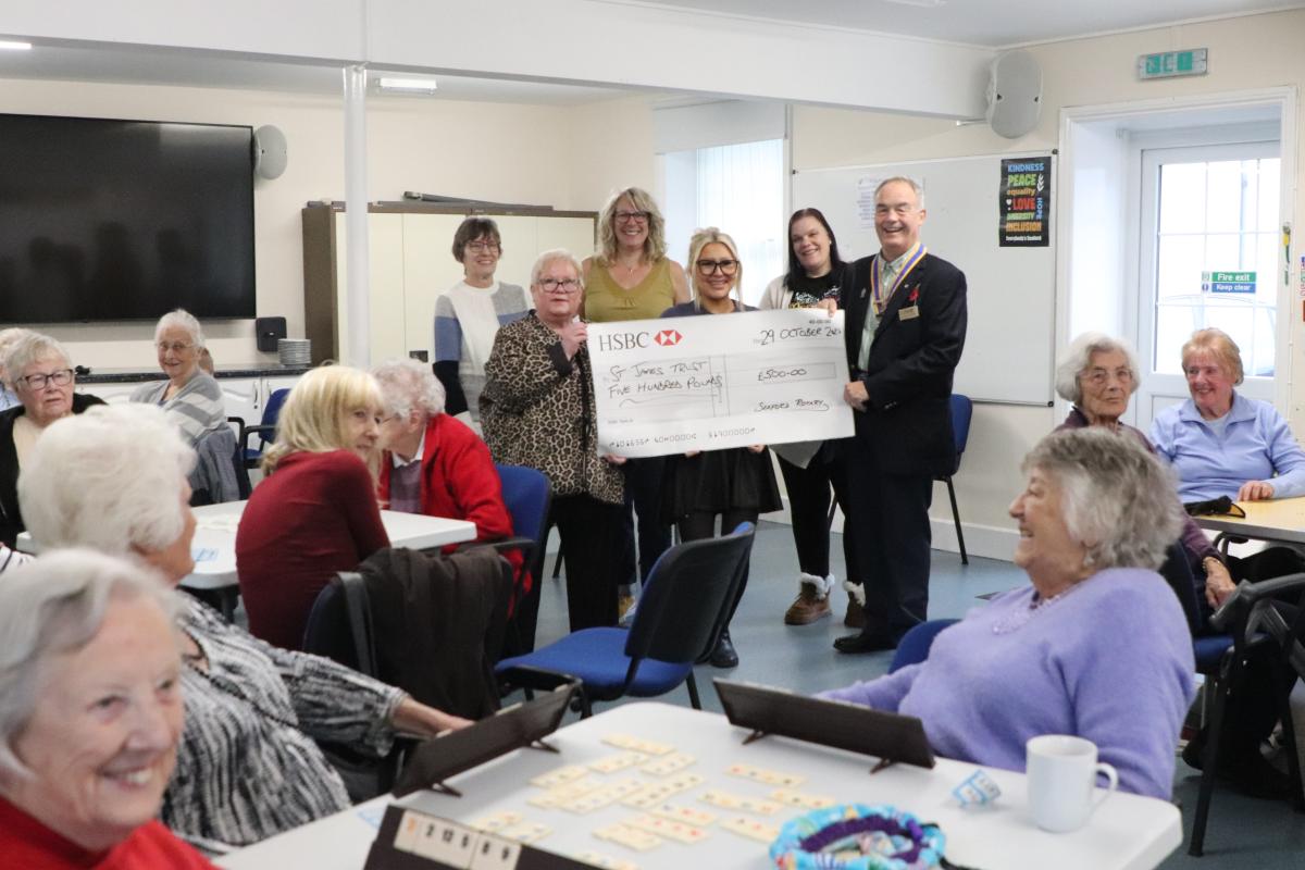 President Mike Barker presenting the grant cheque to Viv Reynolds from St James Trust supported by volunteers (from rear left) Stephanie Baker, Mary Lumley from Seafriends, Anna Tilling and Carrie– Anne Holman
