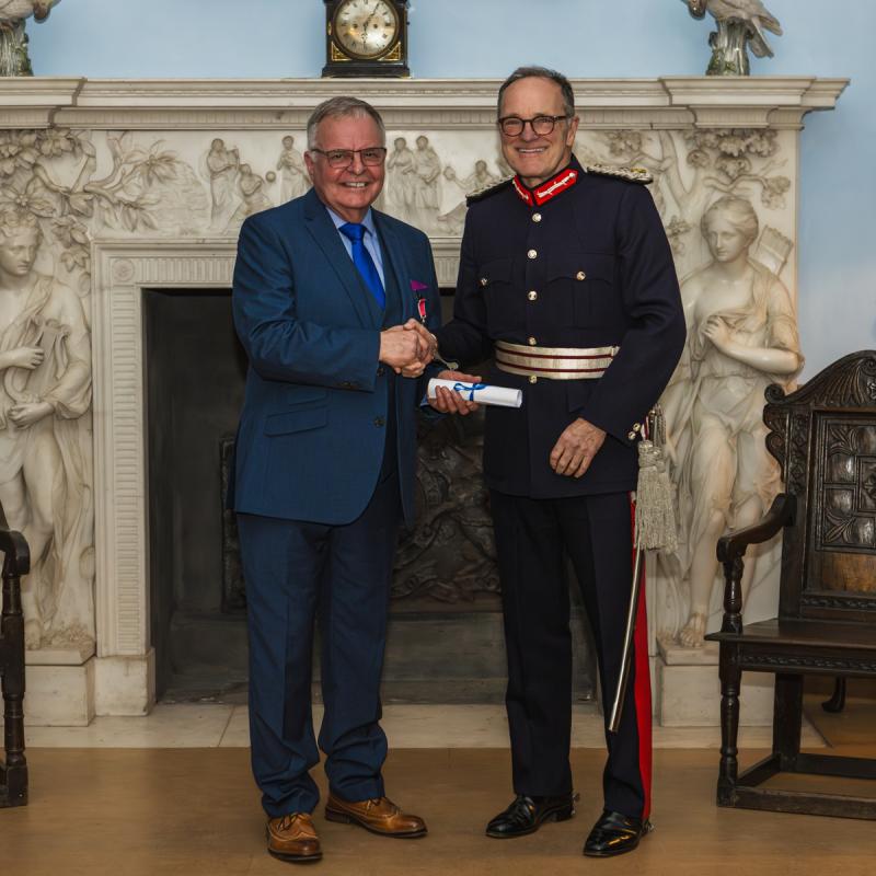 Kevin Walsh being presented with the Award by Alex Scott, Lord Lieutenant of Cumbria