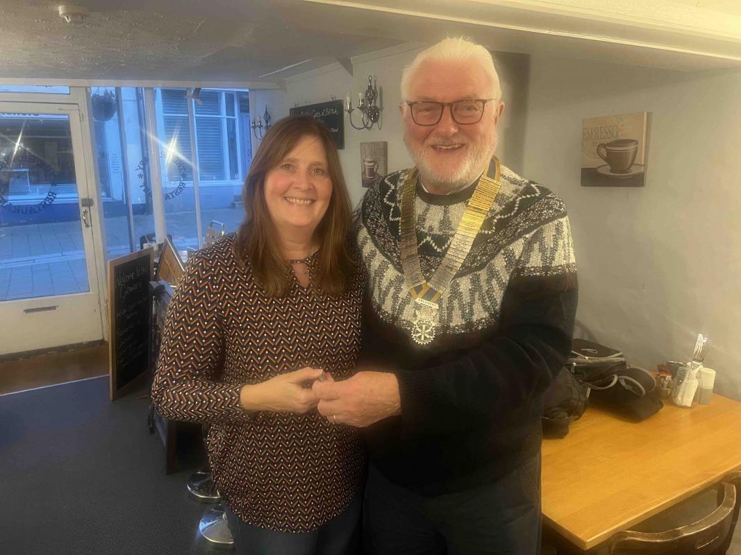 Elizabeth Davey Receives her badge from President Rick