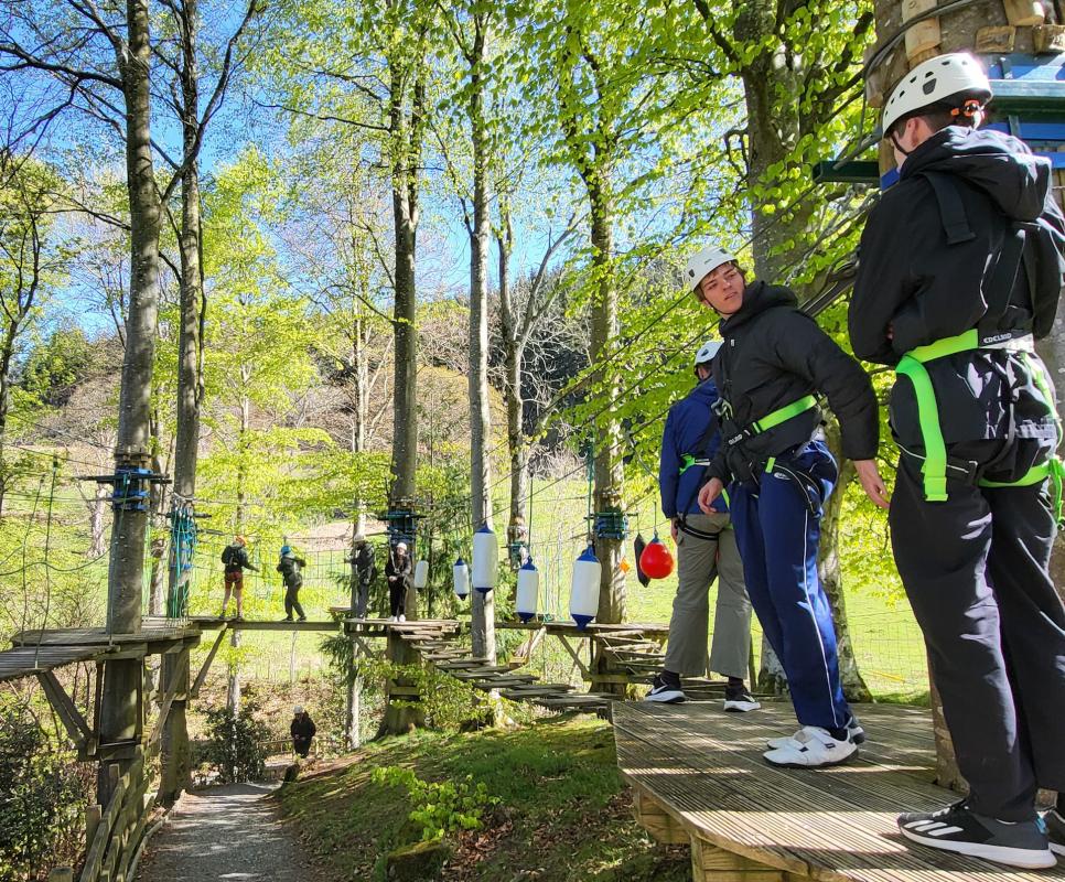 Luke Waldeck, second from right, waits his turn on the High Rope Walk in the tree tops of the Lake District 