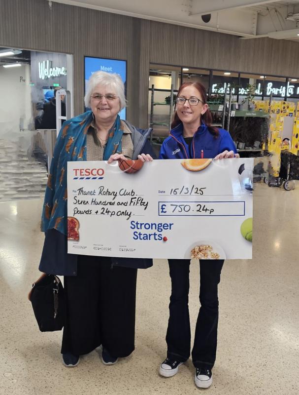 President Maria receives a check from TESCO   