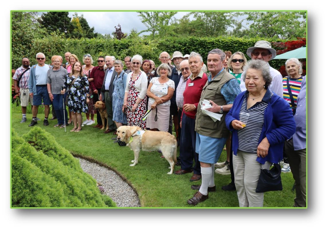 Rotarians & members of Sheffield Visually Impaired Walking Group in Mike's garden