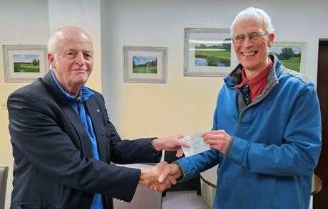 Richard Gibson presenting cheque for £550 to Jim Gleavefrom Marrick Priory.