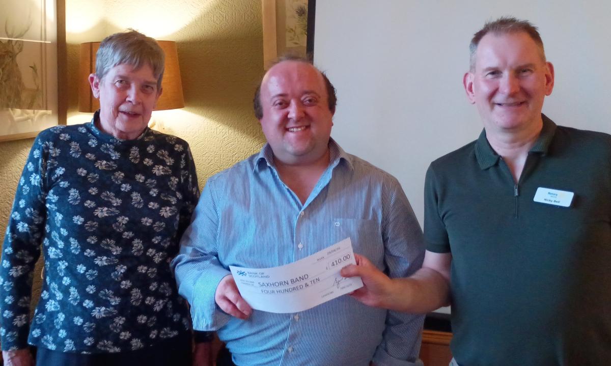 President Mairhi presents cheque to Stuart, with Nicky looking on