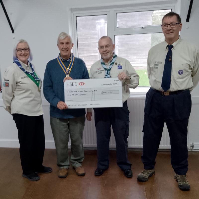 President Clive Livingston presenting the donation to the Scout Leaders