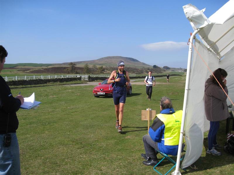 Early runners arrive at mid way checkpoint refreshment tent