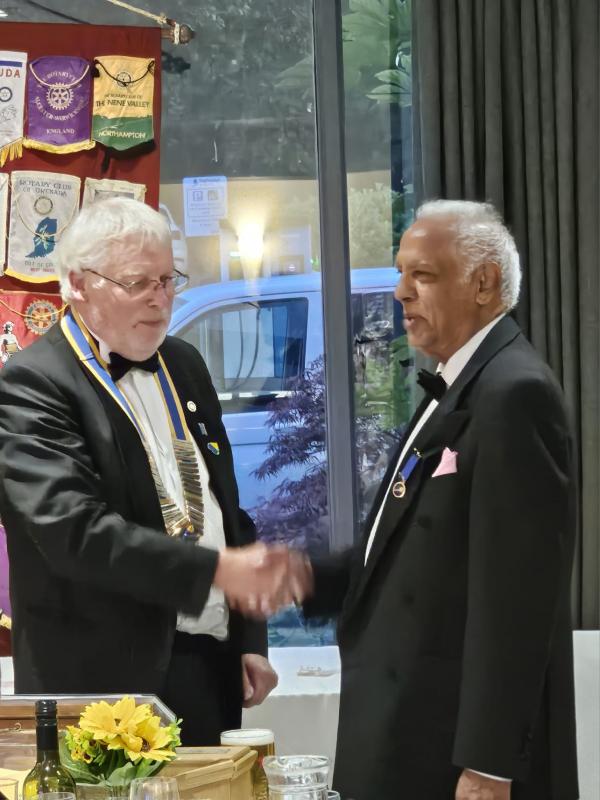 Past president Ramesh Srivastava handing over to New President Simon Maguire.