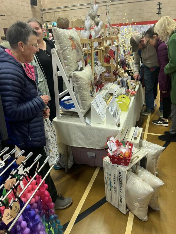 Stall holders getting in the Festive spirit Setting up their stalls before the Christmas Craft fair gets underway!