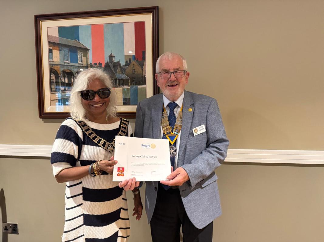 District Governor Kalpana presents Witney Rotary President David Connolly with a Rotary Foundation certificate recognising the Club's contributions.