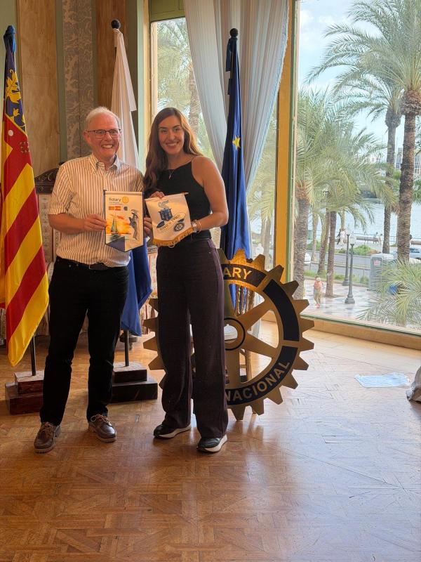 The exchange of bannerettes between Presidents Andrea Corbalan and Mike Douglass.