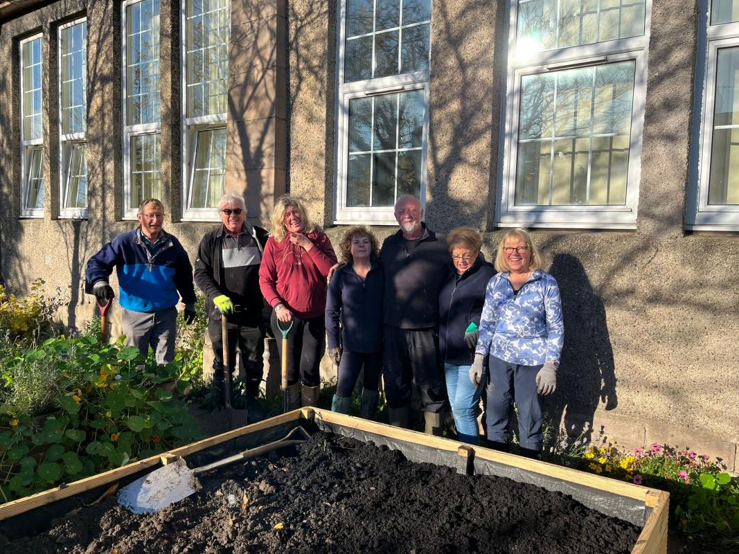 Club members by one of the planters