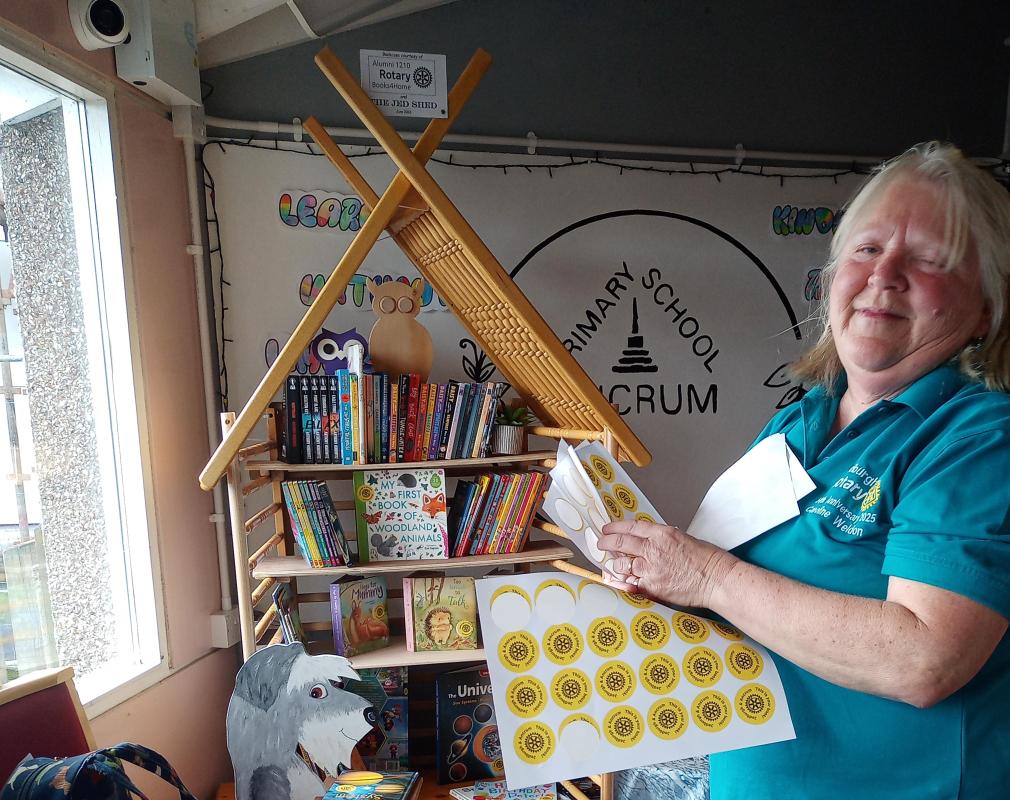 putting stickers onto the donated books ready for the children to choose which to take home