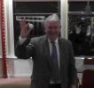 President Mike holding up a golf ball.
