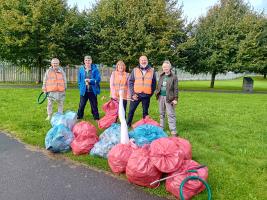 A team of litter pickers with bags full of litter they have removed