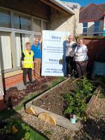 Placing the Rotary in Cardigan Bay plaque recognising their contribution to the ALN Garden at Ysgol Gyfun Aberaeron.