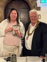 President Peter Gaskell with President Elect Elaine Edwards proudly displays her MBE Medal 