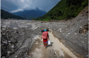 A woman in Nepal carries all her remaining possessions on her back. Click on this link to read the latest update from the Reuters news agency
