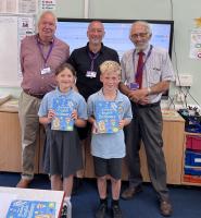 Students with their dictionary 4 Life and a Rotarian