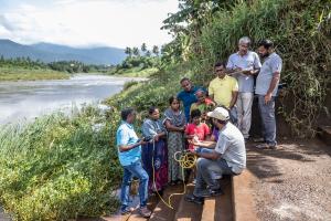 ESRAG members speaking with community members during a river clean-up exercise in South India.